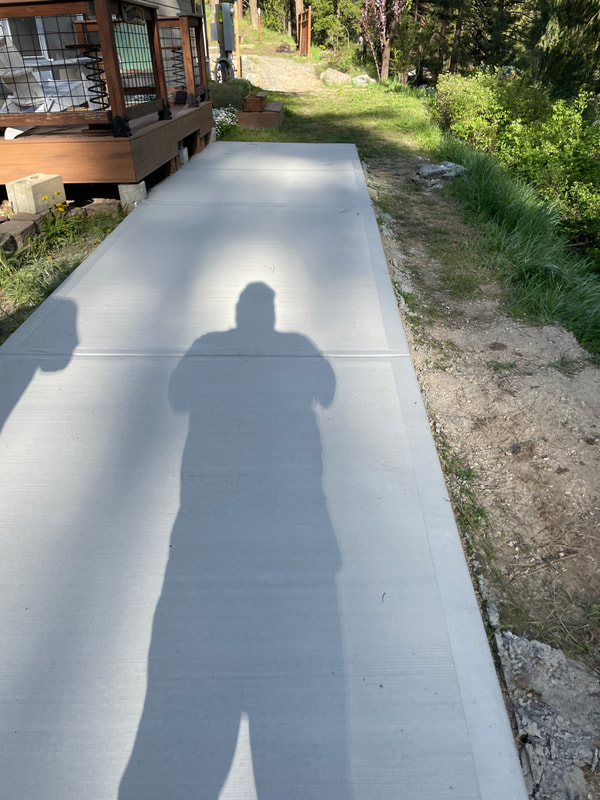 Finished walkway with the photographer's long shadow.