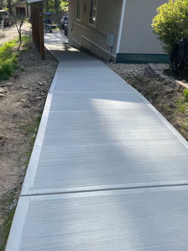 Sunlit new walkway along the house.
