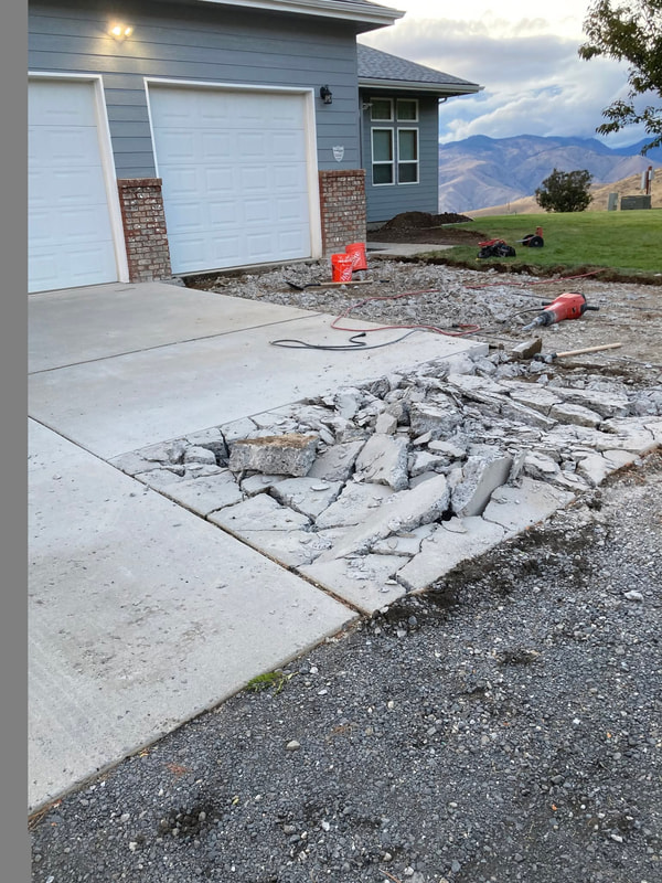 Old driveway broken up beside the garage.