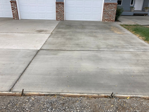 Finished driveway with control joints at the brick garage.