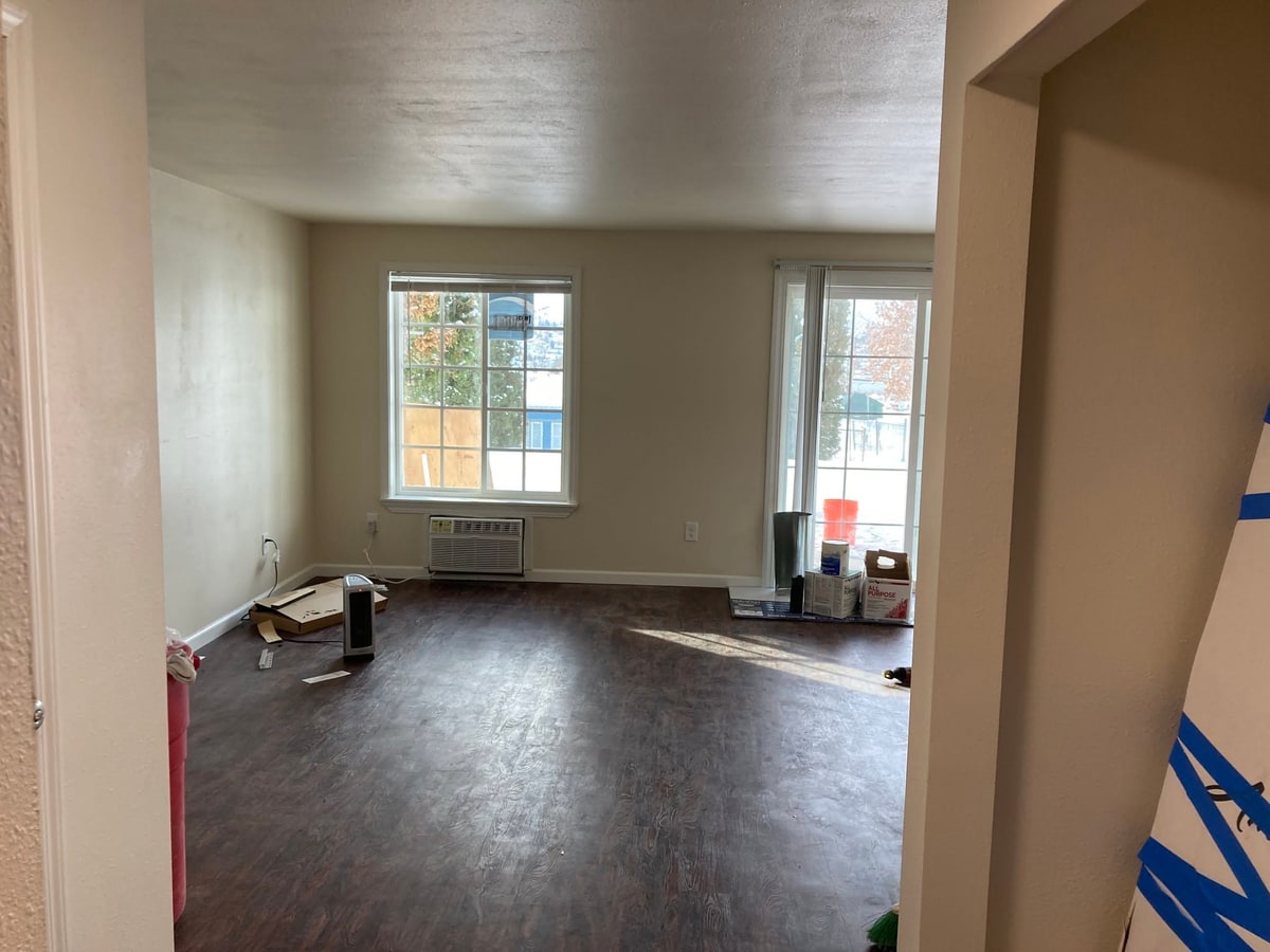Living room with new plank flooring and fresh paint.