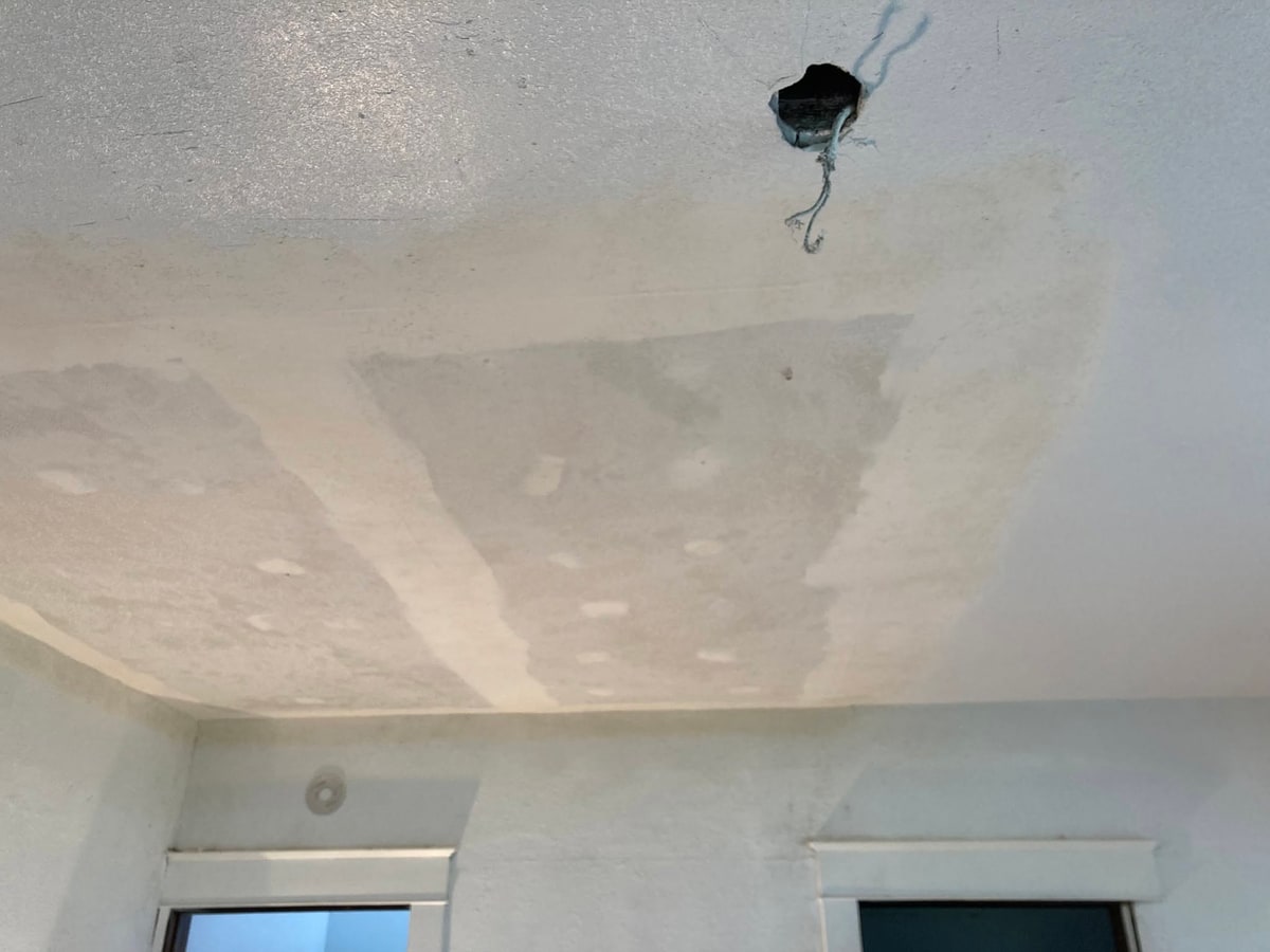 Patched and textured ceiling before paint.